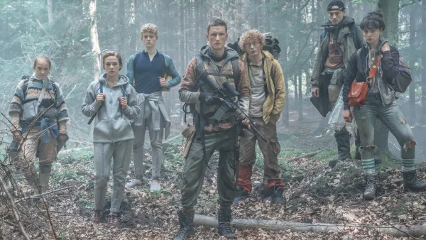 A group of teens stand in the woods in The Rain.