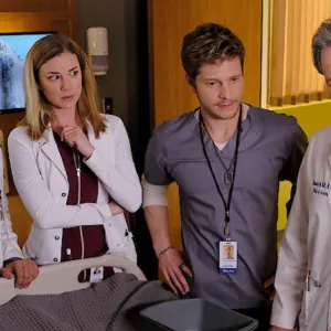Four doctors stand near a patient's bed in The Resident.
