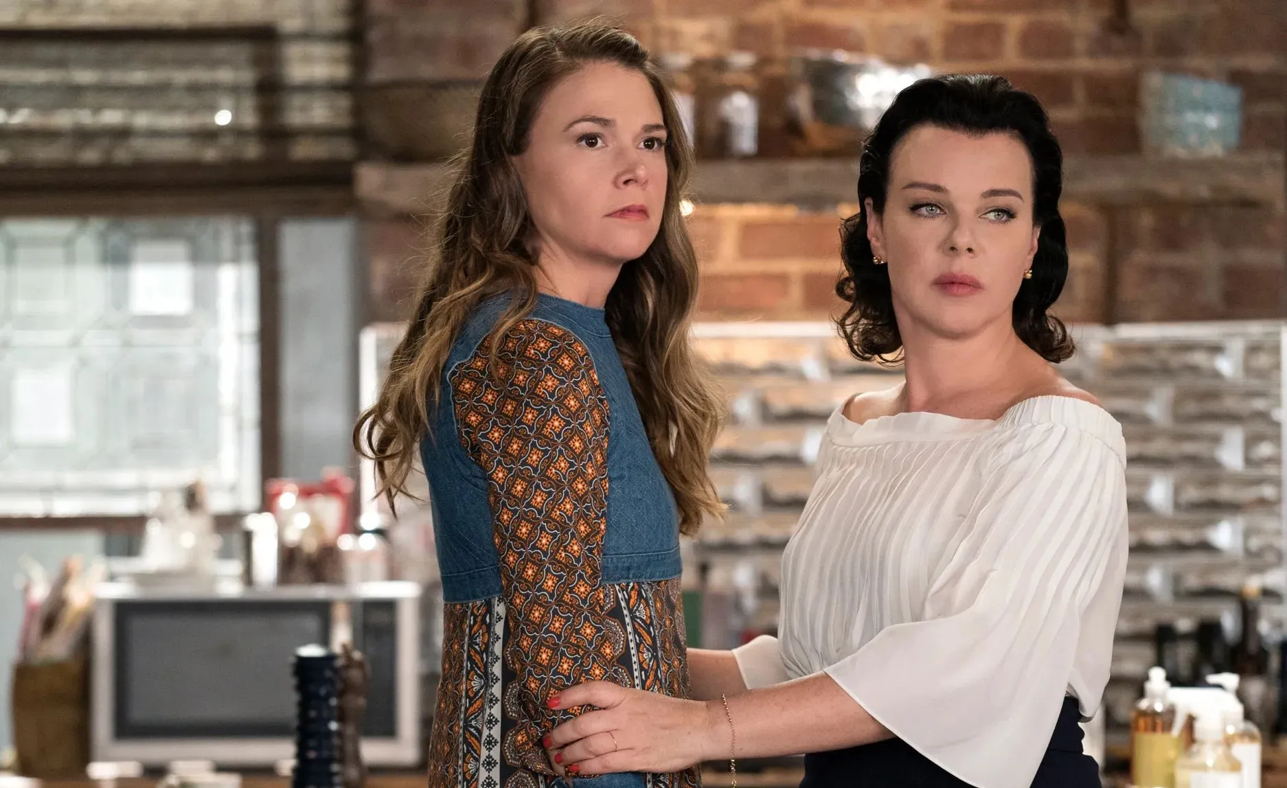 A woman holds another woman in Younger.