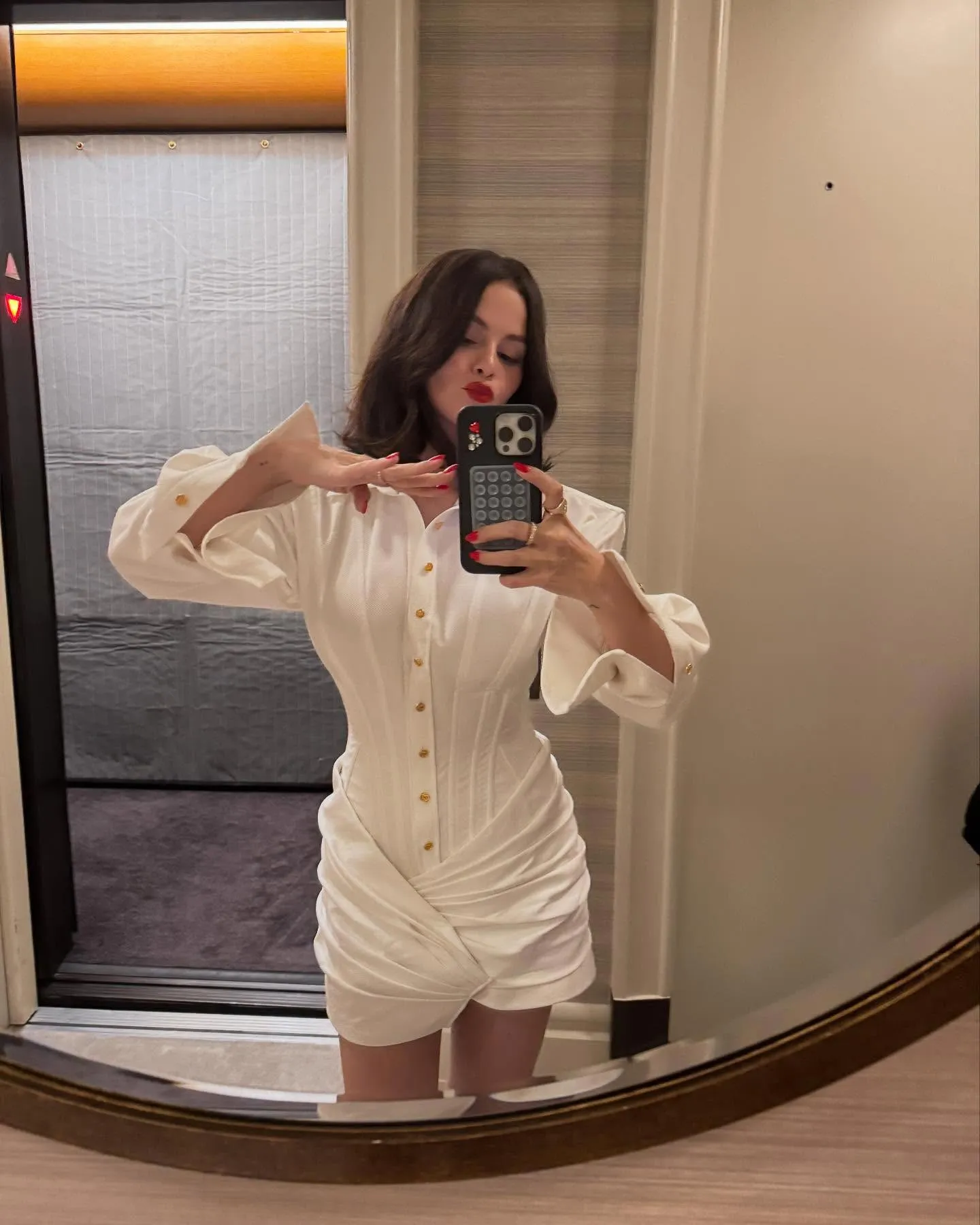 Selena Gomez Glams Up Her White Corset Dress With Cherry Red Lip