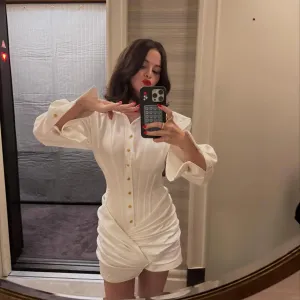 Selena Gomez Glams Up Her White Corset Dress With Cherry Red Lip