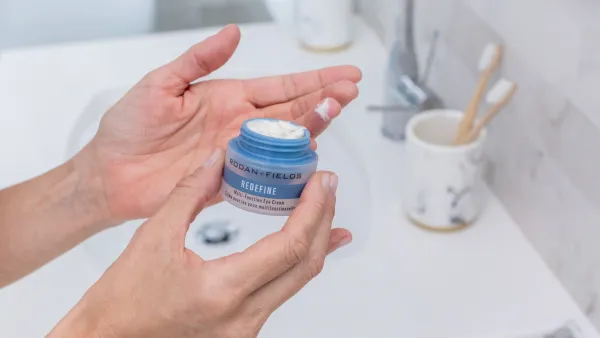 A woman's hands holding cream