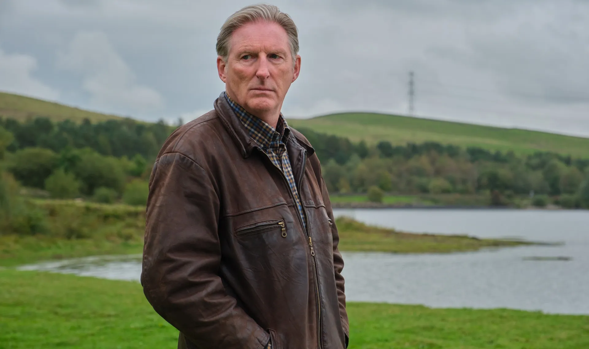 A man stands in a field in Ridley.