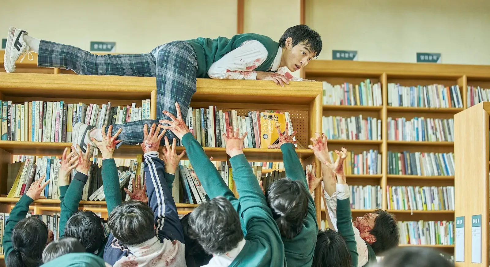 A teen boy tries to evade zombies in All Of Us Are Dead.