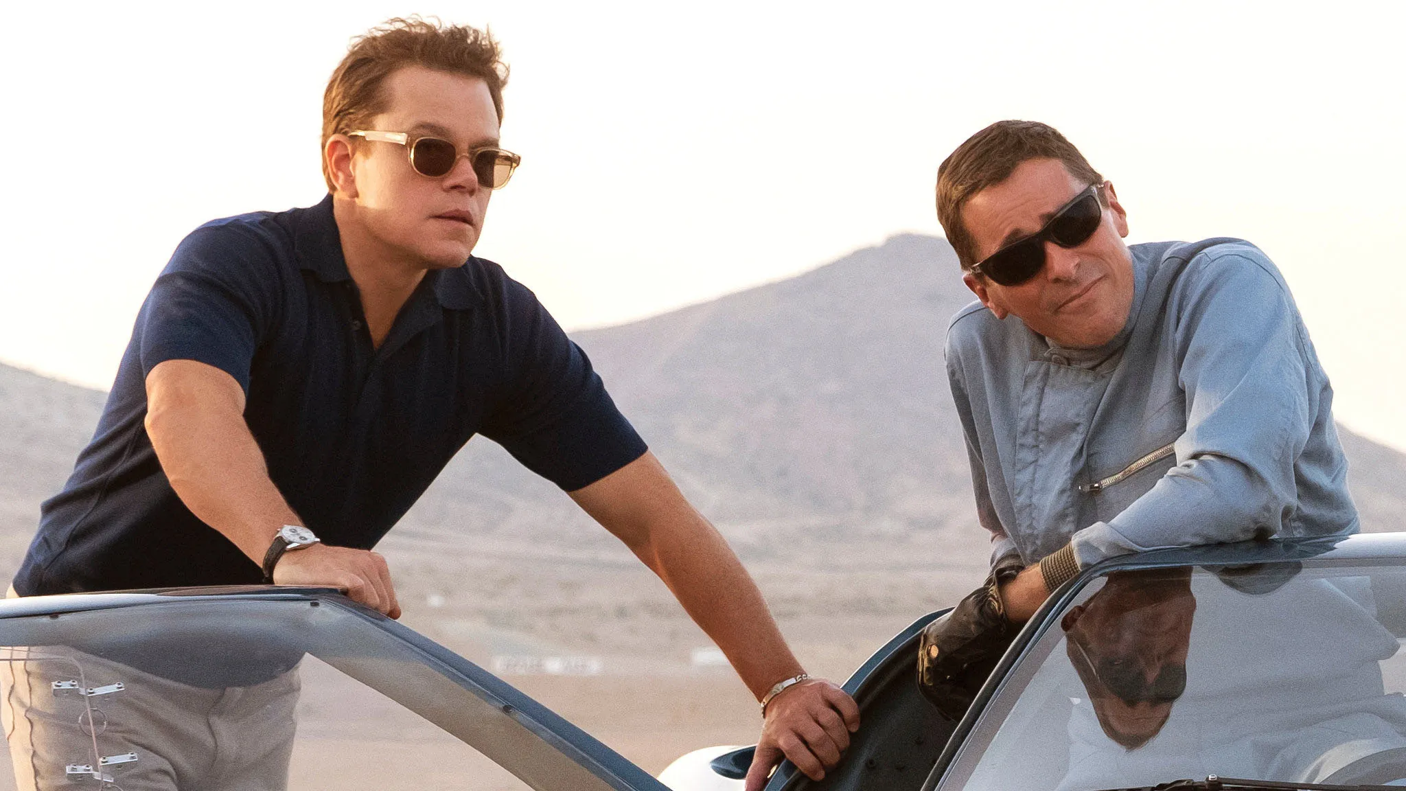 Matt Damon and Christian Bale look at the race track in Ford v Ferrari.