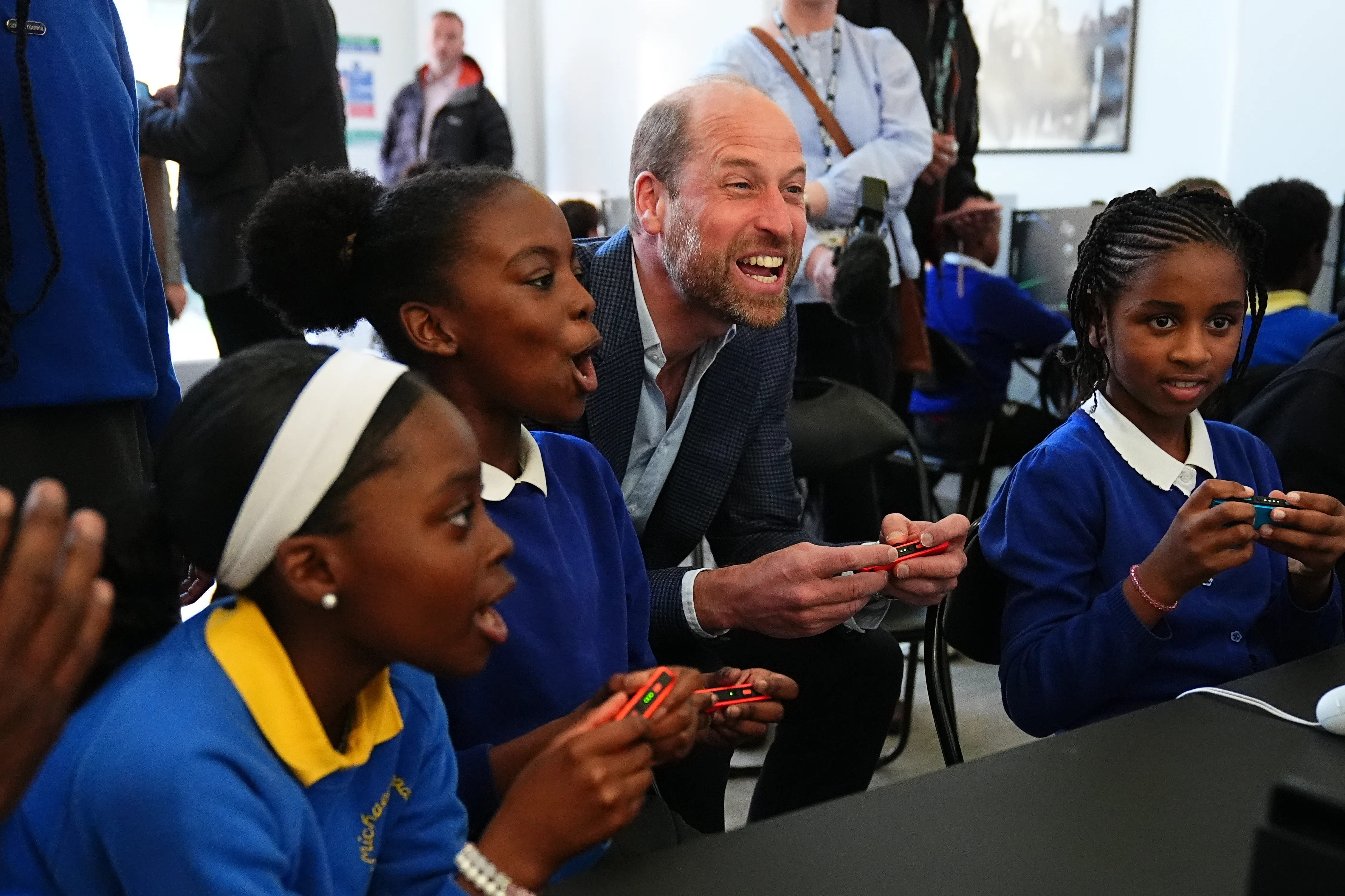 Prince William playing computer games with kids