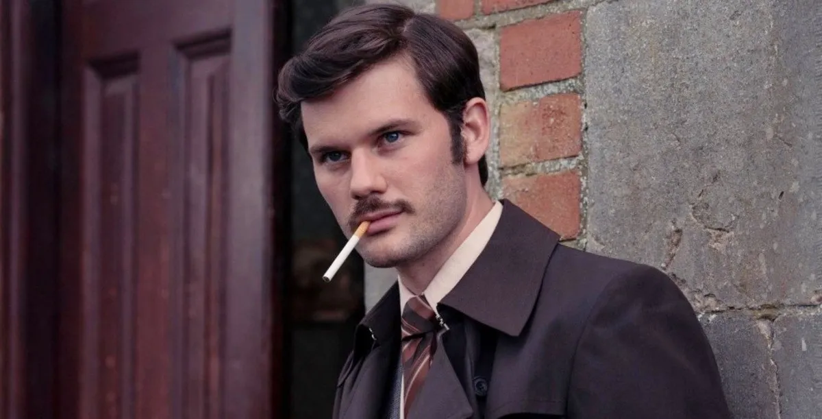 A man smokes a cigarette in Dalgliesh.