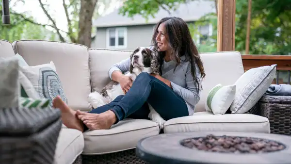 Beautiful Eurasian Woman Spending Time With Her Dog Outside - stock photo