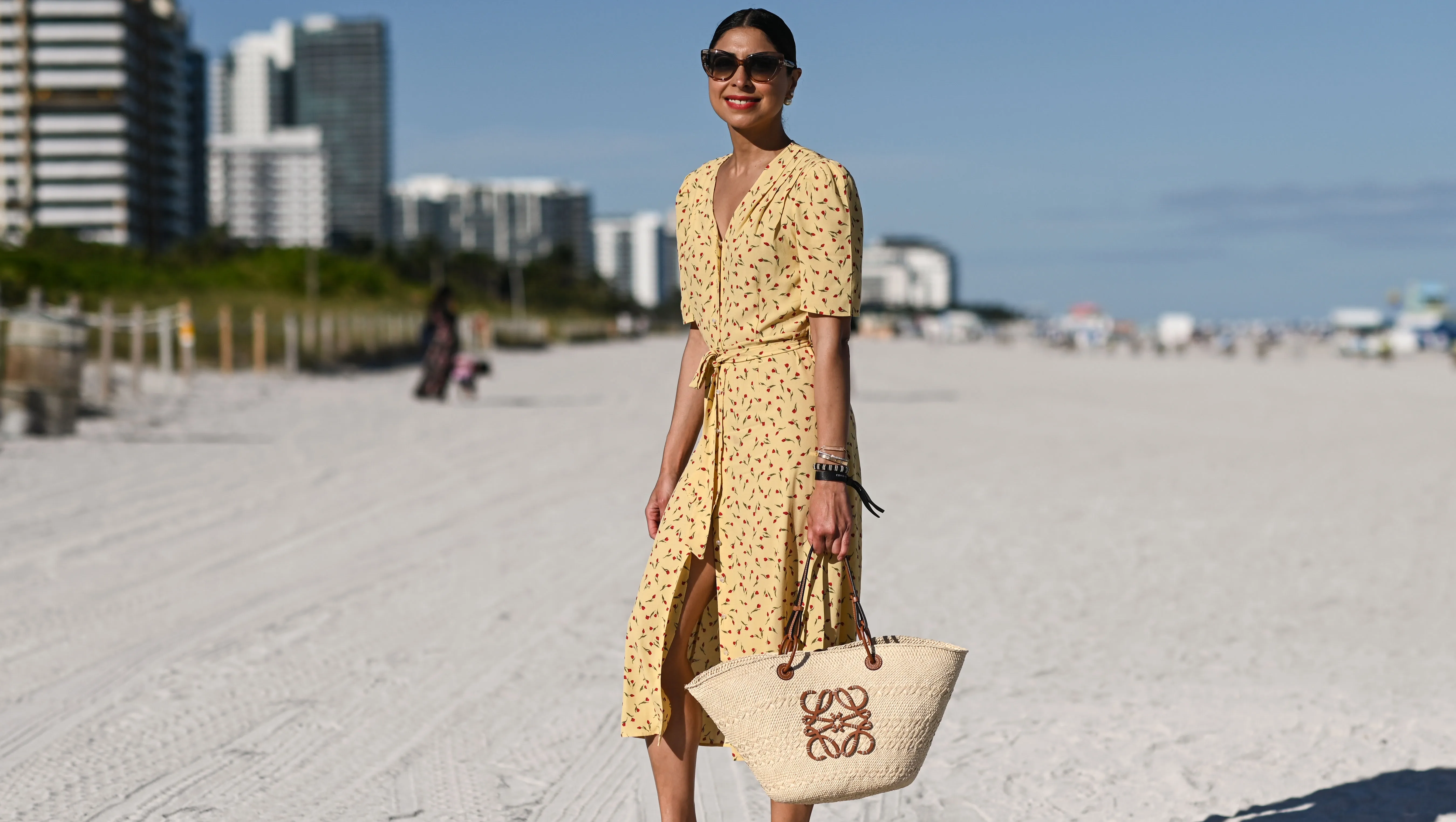 MIAMI, FLORIDA - DECEMBER 01: Sana Rezwan is seen wearing a yellow Rouge dress, Loewe bag and Hermes flats outside UNTITLED Art on December 01, 2021 in Miami, Florida.