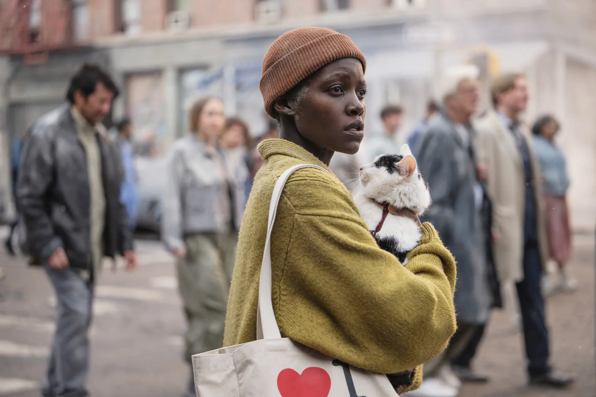 A woman holds a cat in A Quiet Place: Day One.
