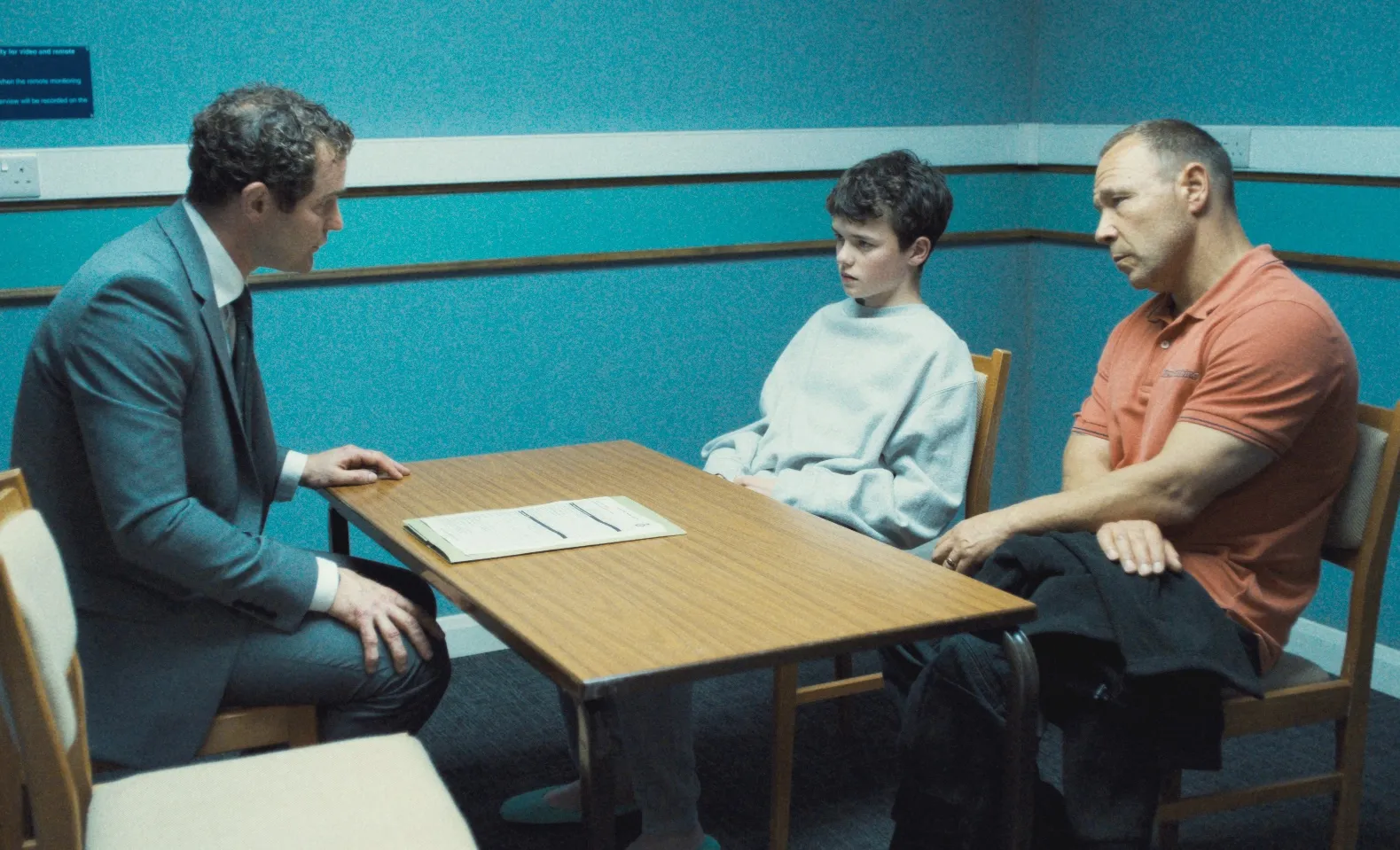 A cop interrogates a boy and his father in Adolescence.