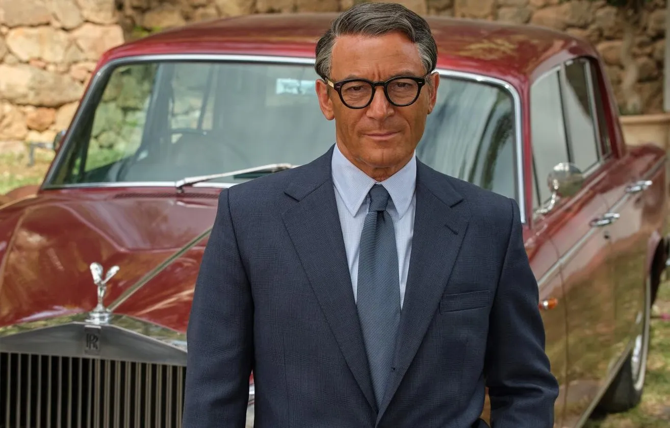 A man stands in front of a car in Archie.