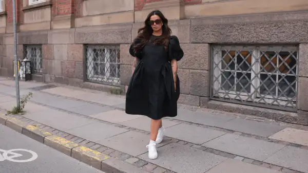 COPENHAGEN, DENMARK - AUGUST 10: Naomi Anwer seen wearing black sunglasses, black short dress, white socks and Copenhagen Studios CPH1 Vitello Off White leather sneaker, on August 10, 2023 in Copenhagen, Denmark. (Photo by Jeremy Moeller/Getty Images for The Wants Social / Copenhagen Studios)