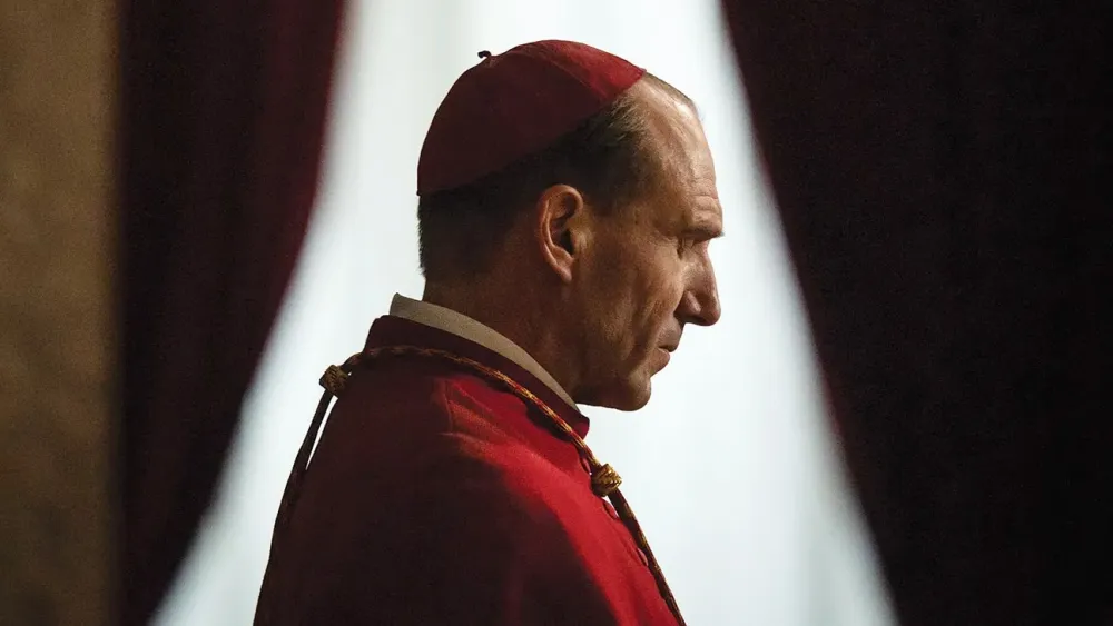 A cardinal bows his head in Conclave.