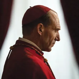 A cardinal bows his head in Conclave.