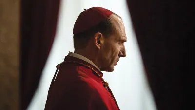 A cardinal bows his head in Conclave.
