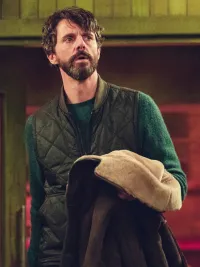 A man holds his coat in Dept. Q.