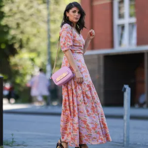 Anna Wolfers wearing colorful wrap dress via Goldig Shop, pink Moschino leather bag and brown heeled clogs on May 31, 2021 in Hamburg, Germany.