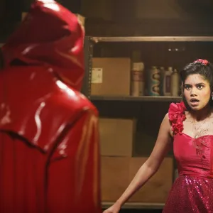 A girl looks at a masked stranger in Fear Street: Prom Queen.