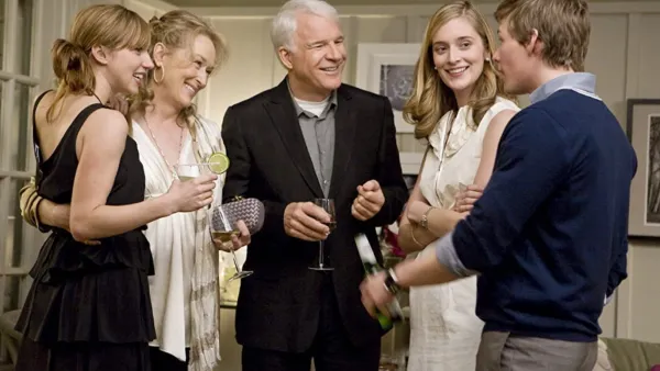 A group of people talk in It's Complicated.