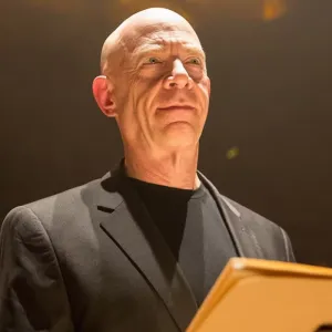 A man stands in front of a lectern in Whiplash.