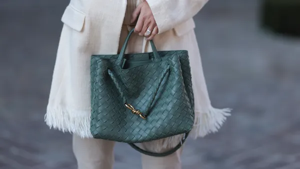 BERLIN, GERMANY - APRIL 02: Leo Eberlin seen wearing Chloe beige ribbed knit blouse with a button-up design down the center, Zara cream-colored straight-leg pants, Chloe long, creamy-white textured blazer with fringes, Leo Mathild diamond jewelry, Bottega Veneta green woven leather Andiamo handbag, on April 02, 2025 in Berlin, Germany. (Photo by Jeremy Moeller/Getty Images)