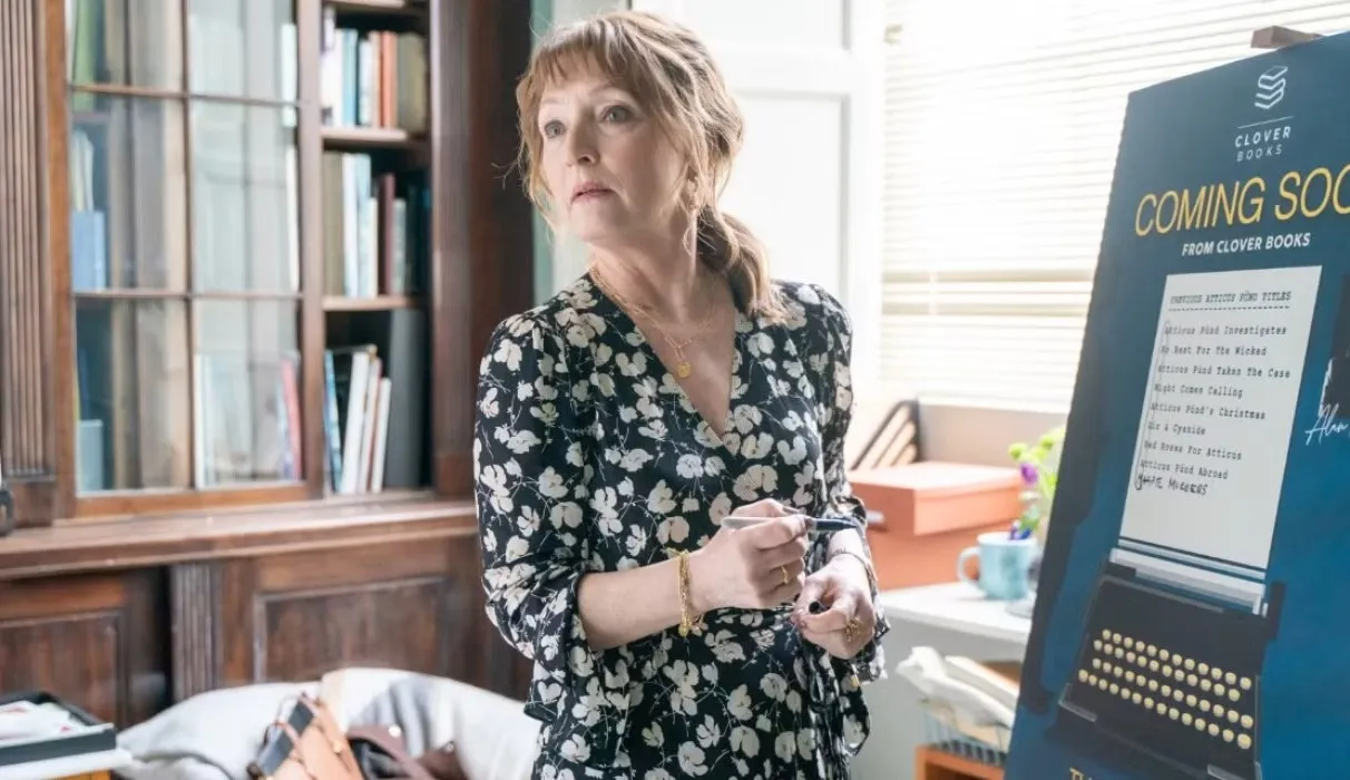 A woman looks away from a presentation in Magpie Murders.