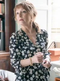 A woman looks away from a presentation in Magpie Murders.