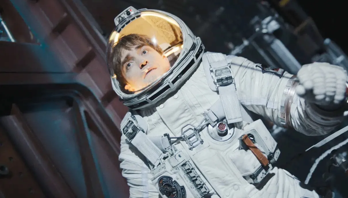 An astronaut floats in space in Mickey 17.