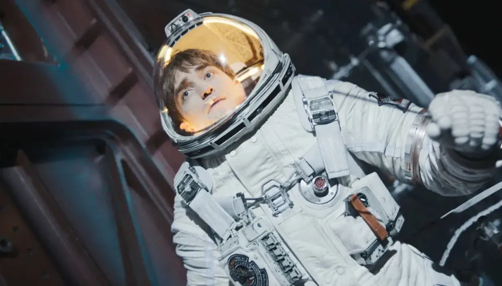 An astronaut floats in space in Mickey 17.