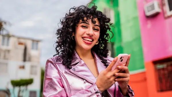 Portrait of young woman using mobile phone outdoors