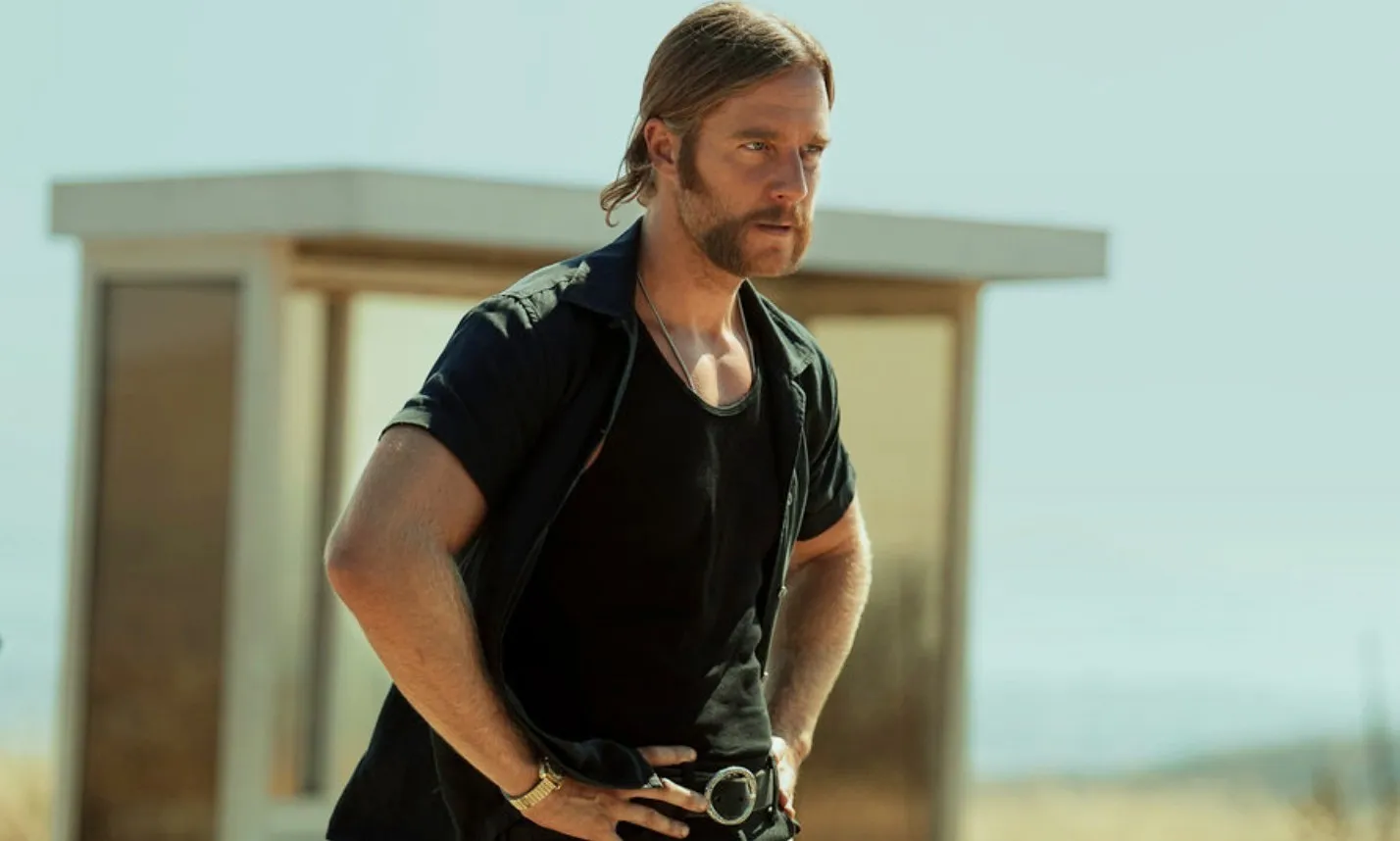 A man stares ahead in Mrs. Davis.