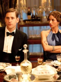 Two people sit at a dinner table in Agatha Christie's Towards Zero.