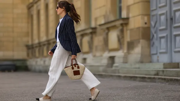 Cleo zu Oettingen-Spielberg wearing navy blue striped Polo Ralph Lauren jacket, white polo and white linen pants and beige Loewe bag via Lodenfrey SS21 on May 10, 2021 in Munich, Germany.