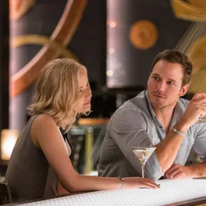 A bartender looks at a man and a woman in Passengers.
