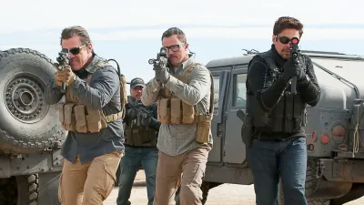Three men aim their guns in Sicario: Day of the Soldado.