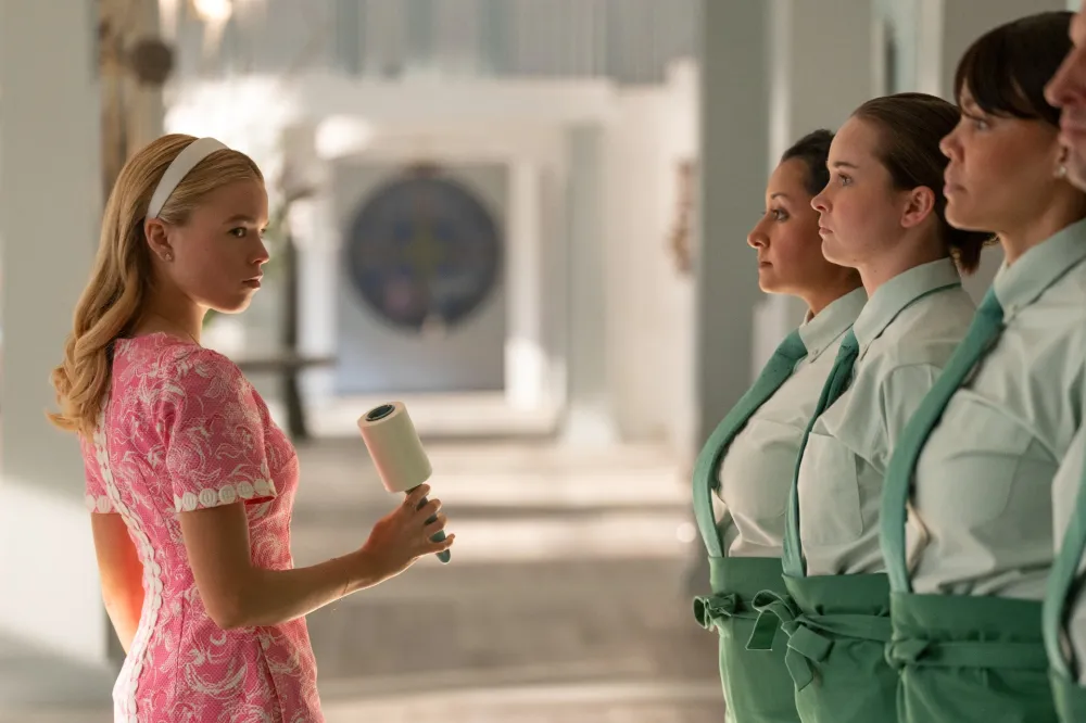 A girl stands in front of a row of women in Sirens.