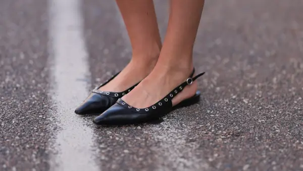 COPENHAGEN, DENMARK - AUGUST 05: A Fashion Week guest is seen wearing pointed black leather flats with silver eyelets from Aeyde before Rotate x Vogue Breakfast during the Copenhagen Fashion Week (CPHFW) SS25 on August 05, 2024 in Copenhagen, Denmark. (Photo by Jeremy Moeller/Getty Images)
