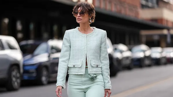 NEW YORK, NEW YORK - FEBRUARY 08: Irina Kro wears dark brown sunglasses, silver earrings, light green cropped Alice + Olivia jacket, light green loose denim jean Alice + Olivia pants, light green Ankvas leather bag, white pointed toe heels Alice + Olivia leather shoes, outside Alice + Olivia, during the New York Fashion week Fall/Winter 2025 on February 8, 2025 in New York, New York. (Photo by Edward Berthelot/Getty Images)