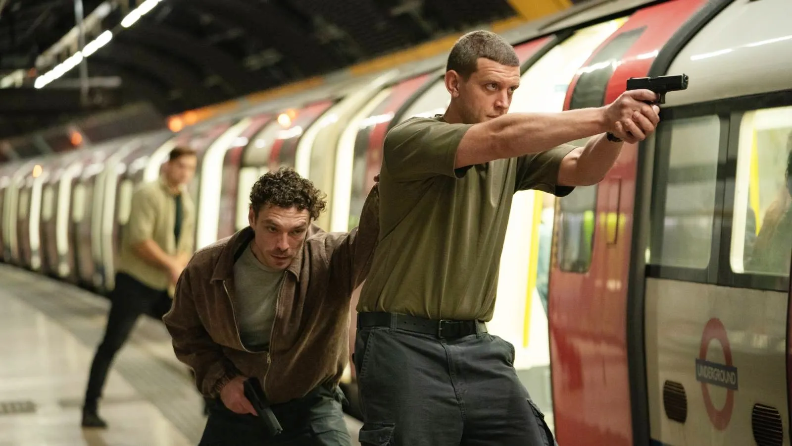 Two men aim their guns in Suspect: The Shooting of Jean Charles de Menezes.'