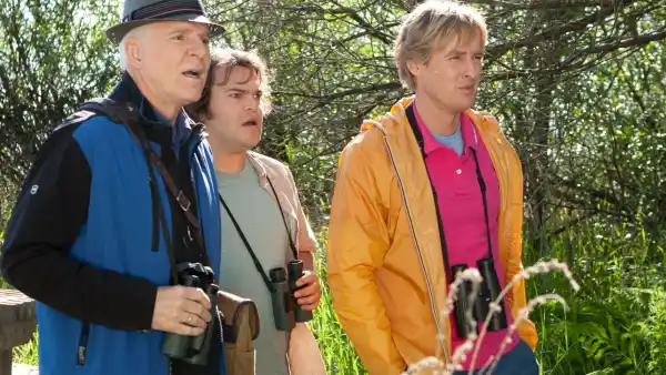 Three men stand in the woods in The Big Year.