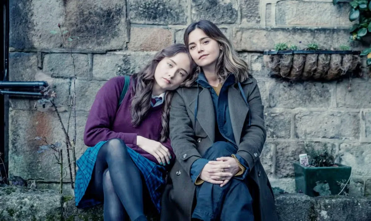 Two women lean against each other in The Jetty.