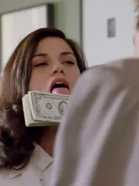 A woman licks some money in The Last Seduction.