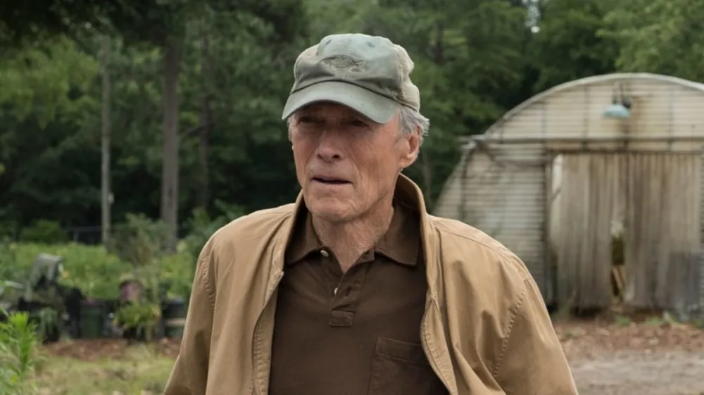 An old man stands in a backyard in 'The Mule.'