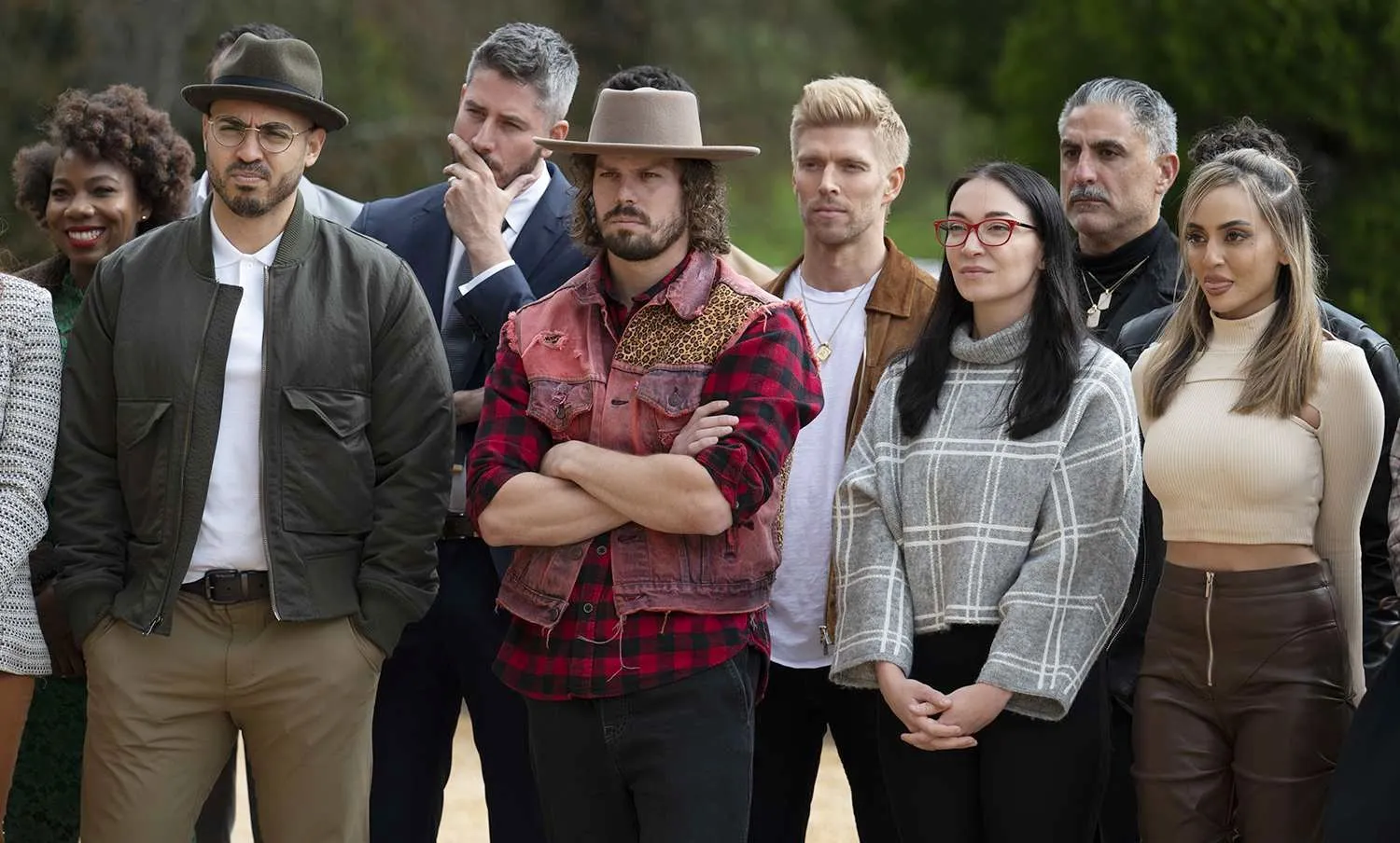 A group of people stand outside in The Traitors.