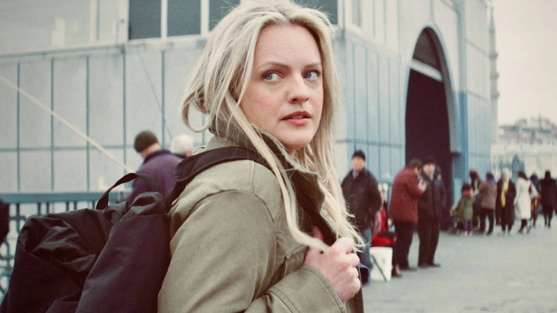 A woman looks behind her in The Veil.