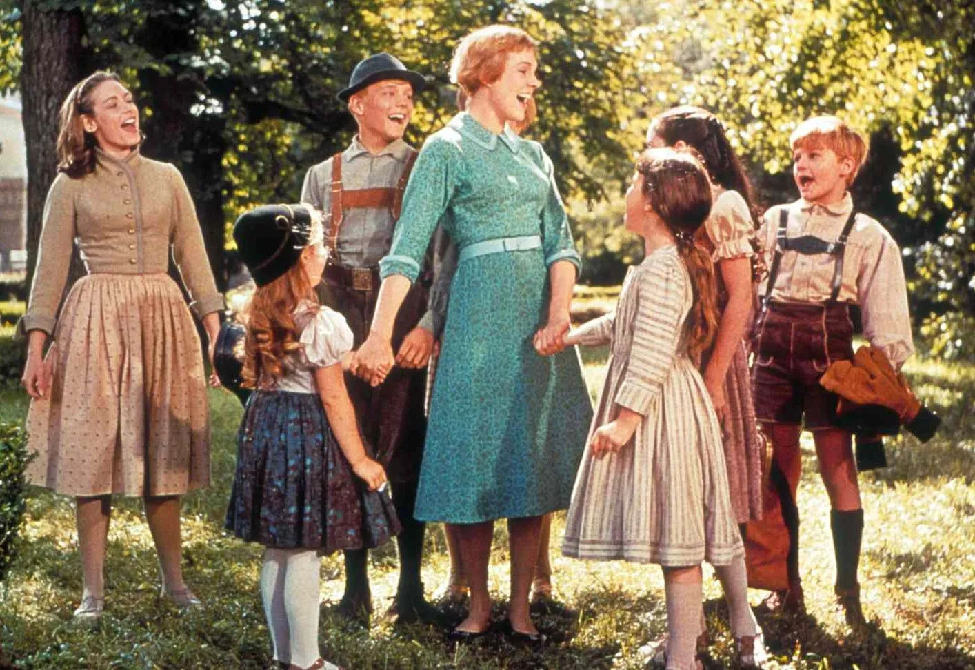 A woman is surrounded by children in The Sound of Music.