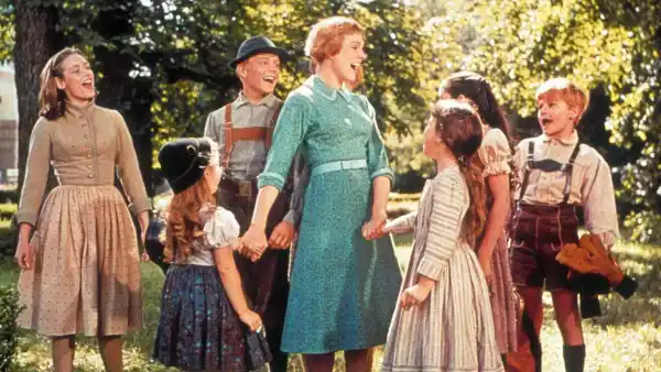 A woman is surrounded by children in The Sound of Music.