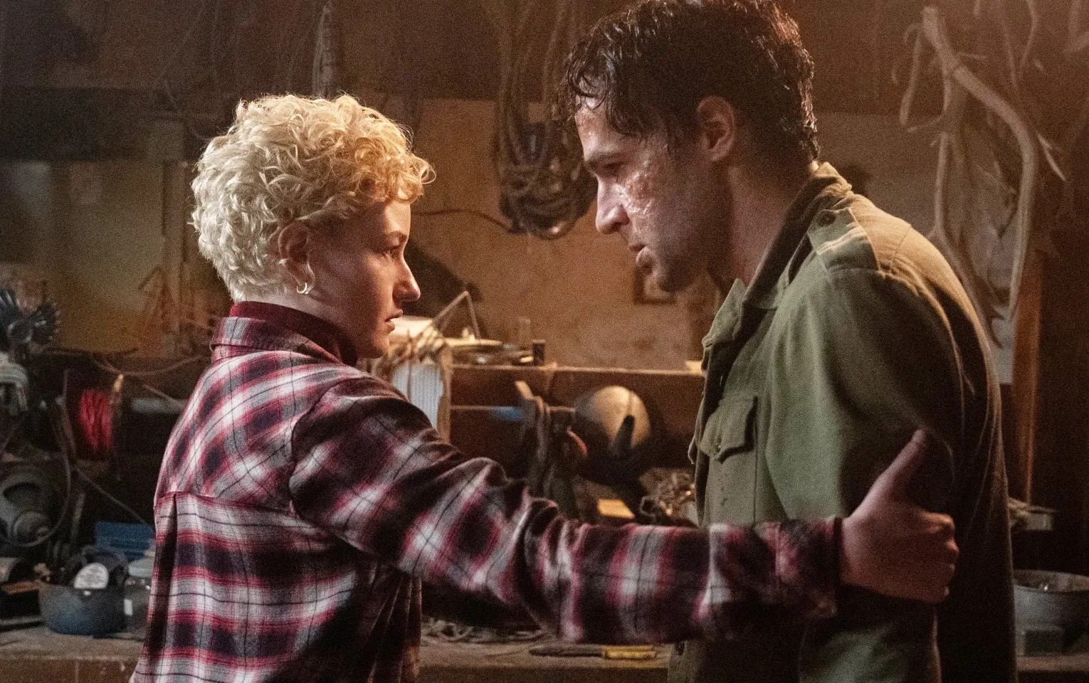 A woman holds on to a man in Wolf Man.