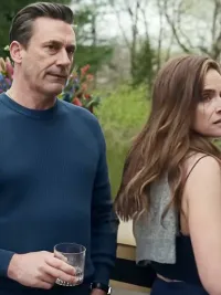 A man and a woman stand next to each other in Your Friends & Neighbors.